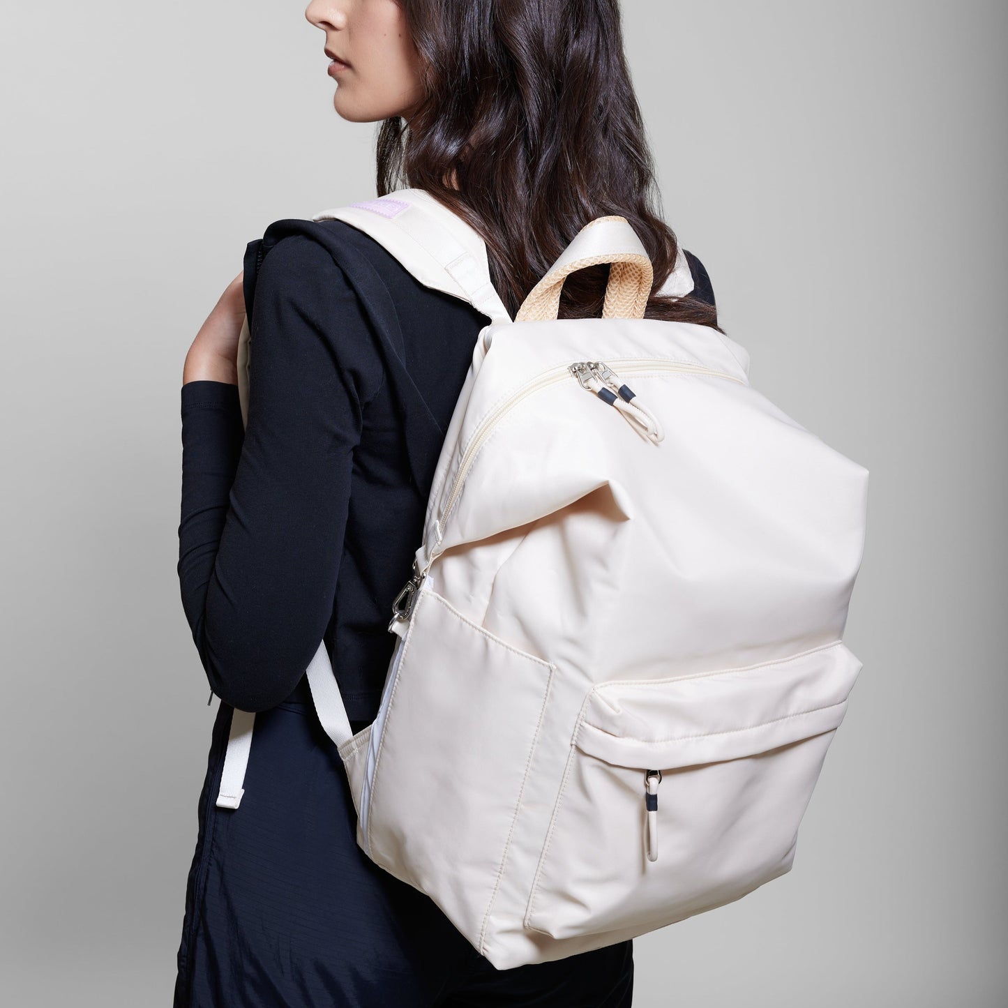 Female model wearing Karma backpack in Ivory
