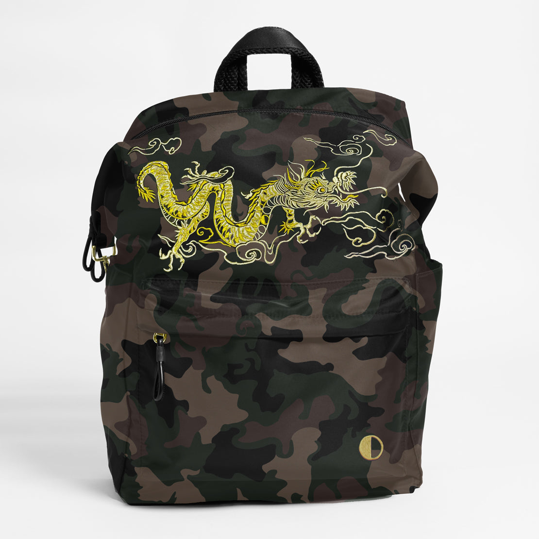 Front Facing view of the Karma Backpack in Green Camo Nylon with intricate dragon embroidery. Backpack has a top handle and a convertible strap to carry your backpack as a tote for easy grab and go!