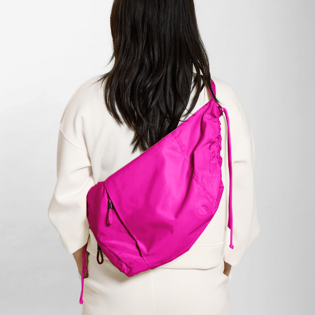 Practice Demilune Shoulder Sling bag in Dragonfruit hot pink color on model in white clothes