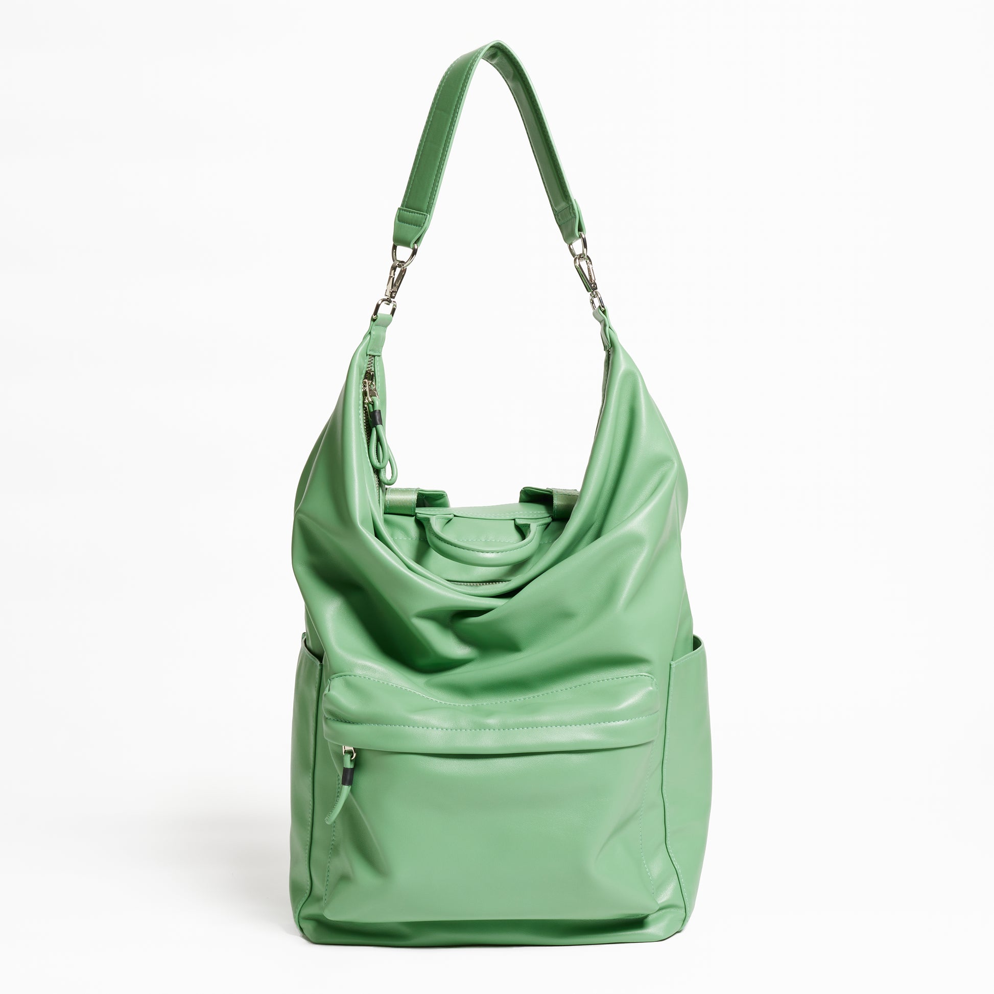 Front Facing view of the Karma Backpack in Aloe Green colored Vegan Leather. Backpack has a top handle and a convertible strap to carry your backpack as a tote for easy grab and go!