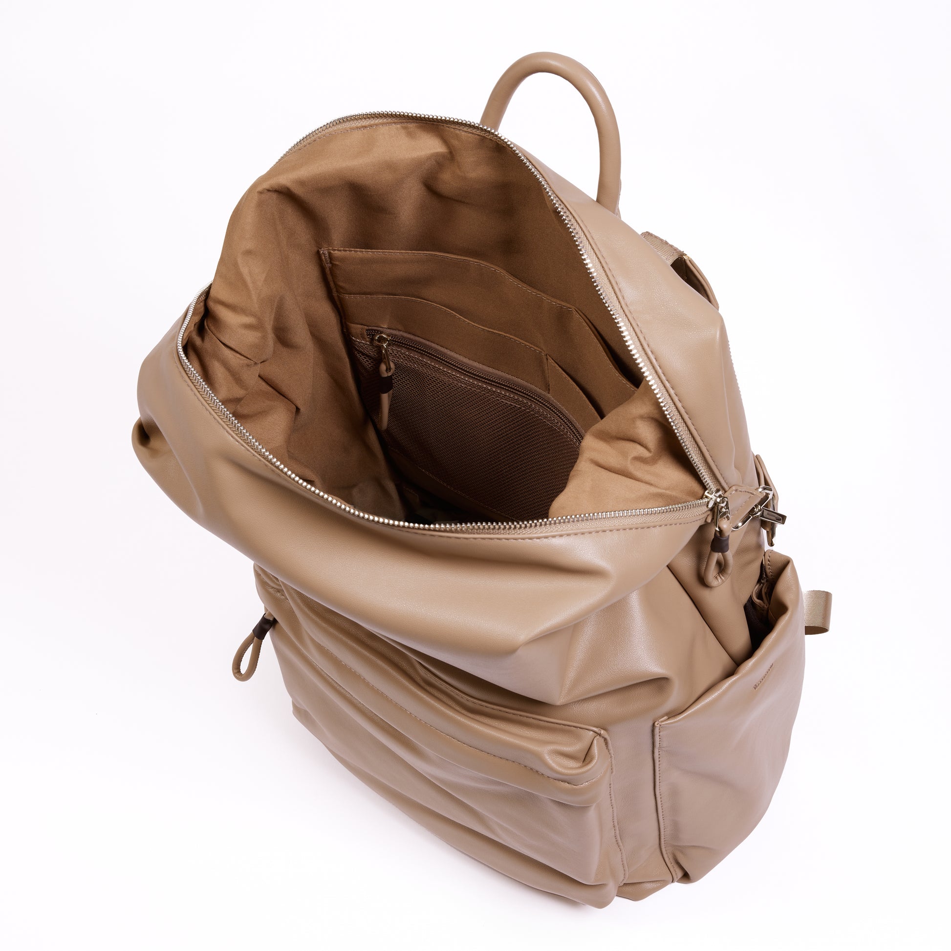 Top inside view of the Karma Backpack in Mushroom colored Vegan Leather. Backpack has a top handle and a convertible strap to carry your backpack as a tote for easy grab and go!