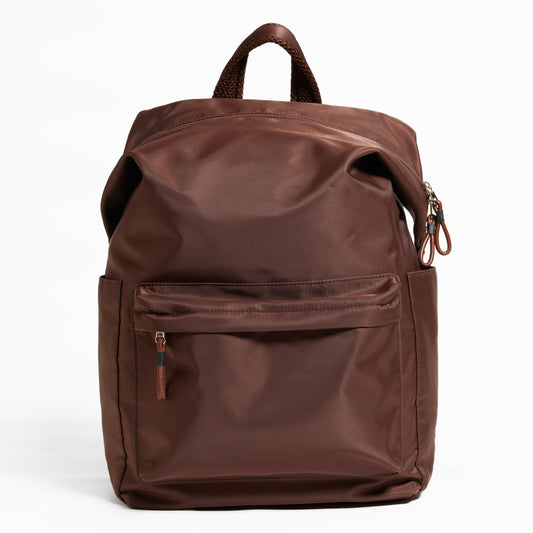 Front Facing view of the Karma Backpack in Woodland Brown Nylon. Backpack has a top handle and a convertible strap to carry your backpack as a tote for easy grab and go!
